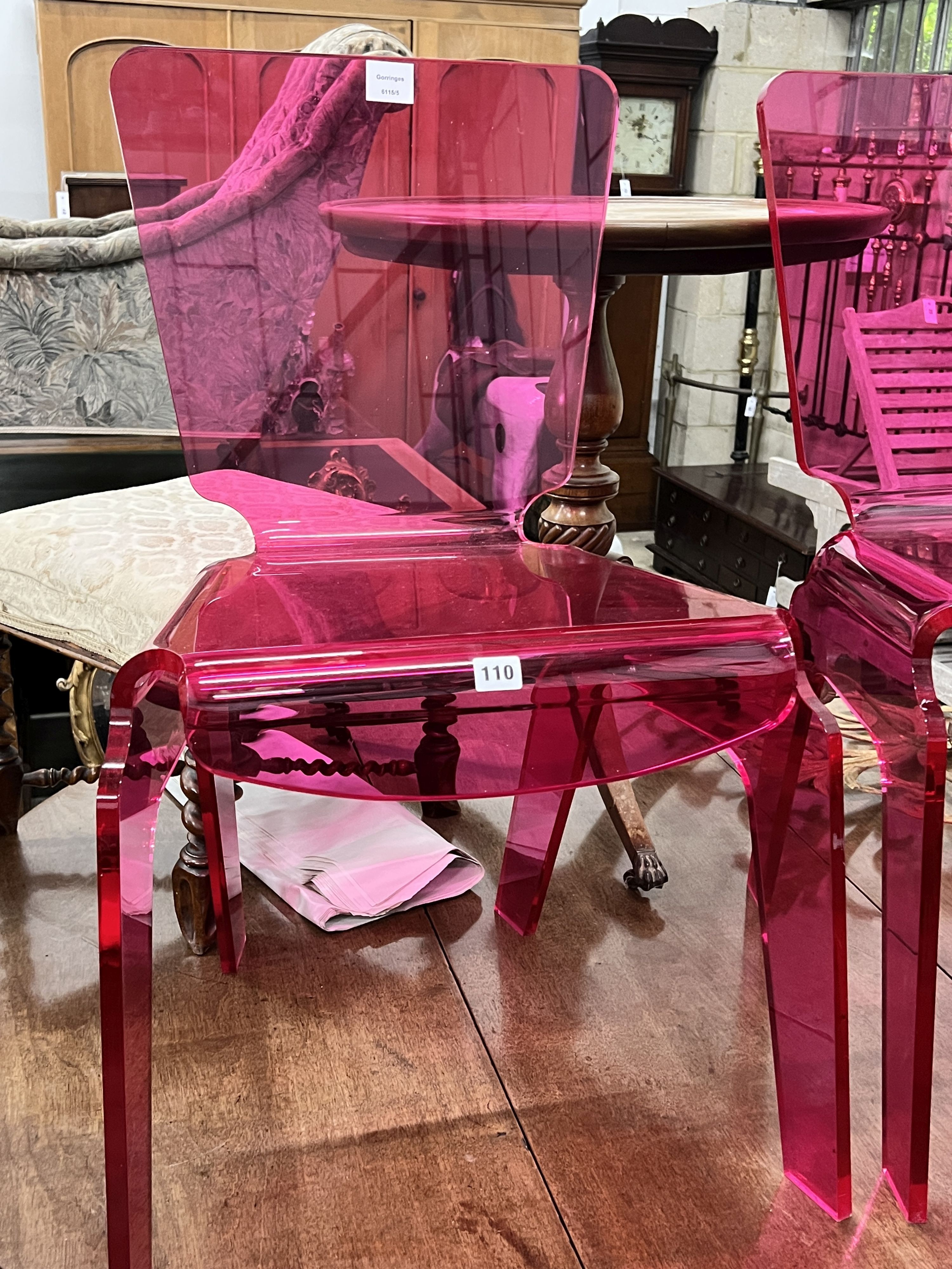 A pair of pink modern design perspex chairs, width 52m, height 84cm